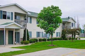 Manitowoc apartment for rent - a white house with a tree in front of it