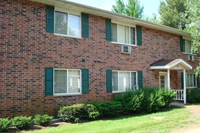 Wisconsin Rapids apartment for rent - a brick house with green shuttered windows and a porch