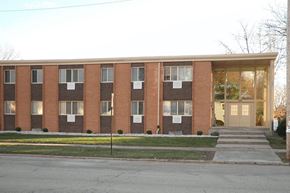 Depere apartment for rent - a brick building with steps in front of it