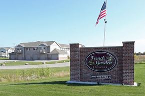 Appleton apartment for rent - a sign for the front garden estates in front of an flag