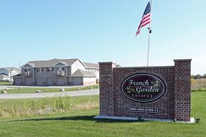 Appleton apartment for rent - a sign for the front garden estates in front of an flag