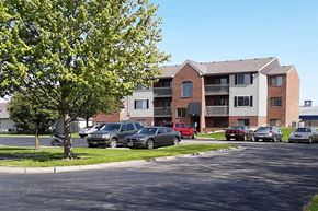 Greenville apartment for rent - a street with cars parked in front of an apartment building