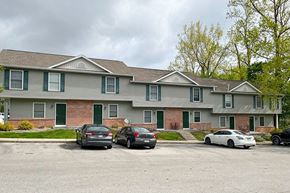 Gosport apartment for rent - a large house with cars parked in a parking lot