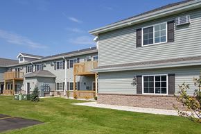 Lomira apartment for rent - a row of houses with a yard in front of them