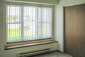 Random Lake apartment for rent - an empty room with a window with white blinds