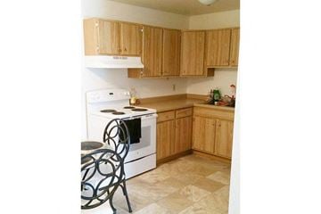 Appleton apartment for rent - a kitchen with a stove and a table and chairs