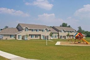 Kasson apartment for rent - a playground in front of a group of houses