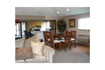Fitchburg apartment for rent - A living room with a couch, chairs, and a dining table.