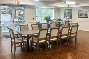 Sumter apartment for rent - A conference room with a table and chairs and an exit sign above it.