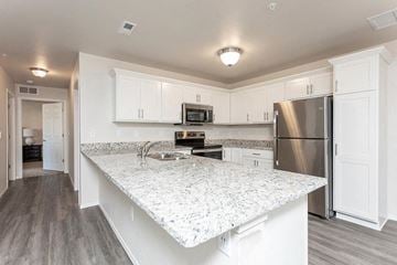 Waterford apartment for rent - A kitchen with a granite countertop and stainless steel appliances.