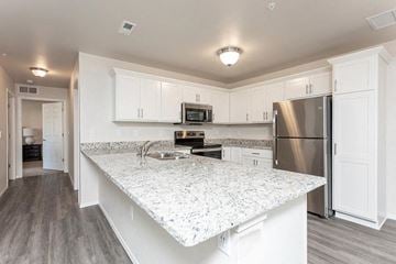 Waterford apartment for rent - A kitchen with a granite countertop and stainless steel appliances.