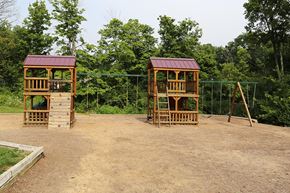 Florence apartment for rent - a playground with two wooden structures   and trees