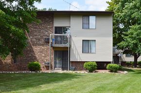 Appleton apartment for rent - A two-story residential building with a balcony on the second floor.