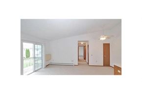 Howard apartment for rent - an empty living room with white walls and a balcony