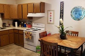 Neenah apartment for rent - a kitchen with a wooden table and a stove