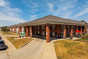 Terre Haute apartment for rent - A building with a green sign in front of it.