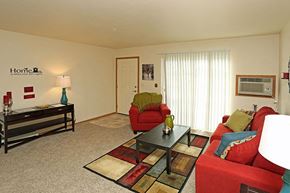 Neenah apartment for rent - a living room with red furniture and a table