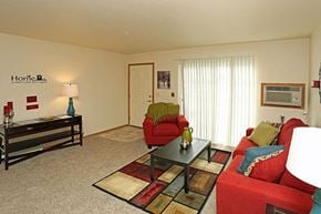 Neenah apartment for rent - a living room with red furniture and a table