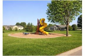 Yankton apartment for rent - A playground with a yellow slide and a blue bench.