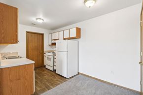 Lawrence apartment for rent - A kitchen with white appliances and wooden cabinets.