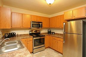 Horicon apartment for rent - a kitchen with stainless steel appliances and wooden cabinets