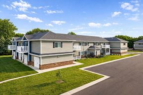 New Richmond apartment for rent - A row of houses with a clear blue sky above them.