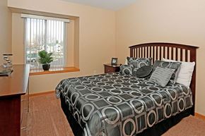 Port Huron apartment for rent - a bedroom with a bed and a window