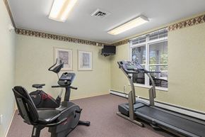 Oshkosh townhouse for rent - a gym with exercise equipment and a large window