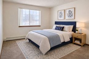 Grundy Center apartment for rent - A bedroom with a large bed and a window.