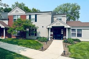 Sussex apartment for rent - A house with a grey siding and a red brick chimney.
