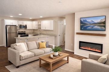 Beaver Dam apartment for rent - A modern living room with a fireplace and a painting of a mountain lake on the wall.