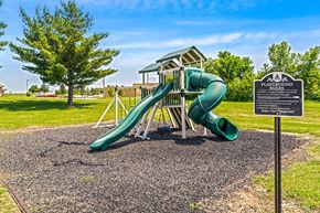 Marshalltown apartment for rent - A playground with a green slide and a sign that says "Playground Rules".