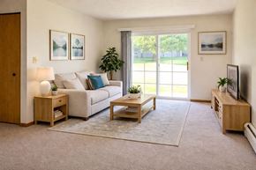 Mason City apartment for rent - A living room with a couch, a coffee table, and a television.