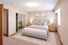 Newton apartment for rent - A bedroom with a bed, nightstands, and a mirror.