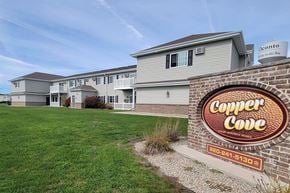 Oconto apartment for rent - A sign for Copper Cove is in front of a building.