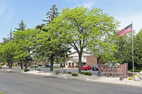 Fond Du Lac apartment for rent - a city street with a sign and an flag
