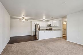 New Richmond apartment for rent - A spacious living room with a kitchenette in the background.