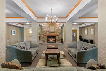 Oshkosh townhouse for rent - a living room with couches and a fireplace
