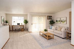 Sturgeon Bay apartment for rent - A living room with a couch, chair, and potted plants.