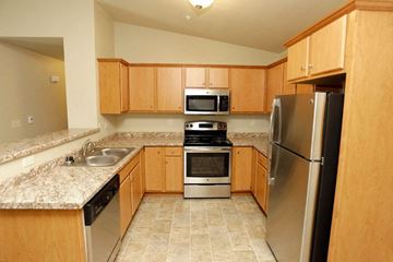 Appleton apartment for rent - a kitchen with wooden cabinets and stainless steel appliances