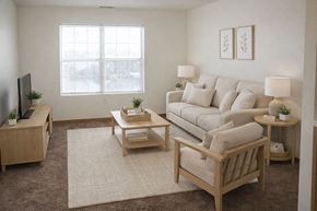 Hays apartment for rent - A living room with a couch, coffee table, and television.