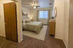 Rifle apartment for rent - A bedroom with a bed, nightstand, and a ceiling fan.