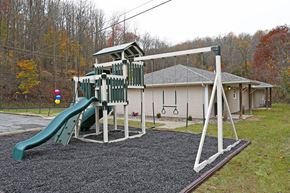 Fairmont apartment for rent - a playground with a swing set and a slide