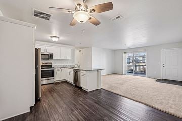 New Richmond apartment for rent - A spacious kitchen with white cabinets and a ceiling fan.