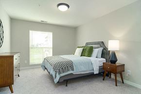 Hugo apartment for rent - a bedroom with a bed and a night stand