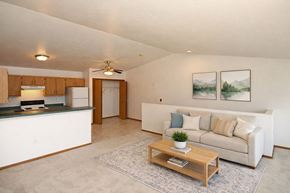 Sturgeon Bay apartment for rent - A living room with a couch, a coffee table, and two pictures on the wall.