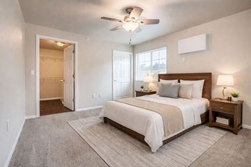 Wisconsin Rapids apartment for rent - A bedroom with a large bed and a ceiling fan.