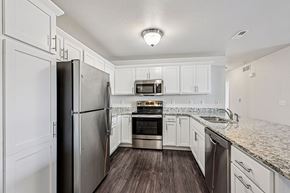 New Richmond apartment for rent - A kitchen with a refrigerator, oven, microwave, and sink.