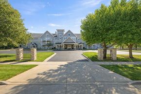 Oshkosh townhouse for rent - A large, well-maintained building with a driveway leading up to it.