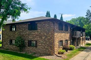 Shawano apartment for rent - A brick building with a balcony on the right side.